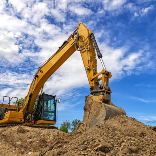 A stopping yellow excavator for rest, at fluffy clouds